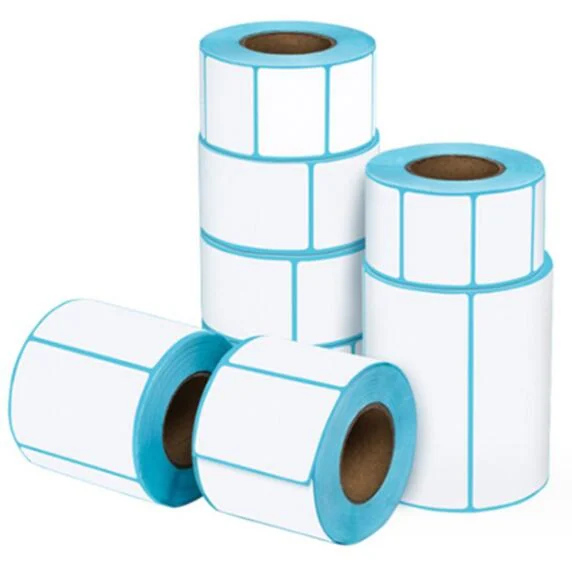 Rolls of blank white thermal transfer labels on cardboard cores with blue liners