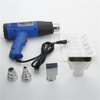 Blue dual-temperature heat gun with power cord, four metal nozzle tips and instruction sheet on white background