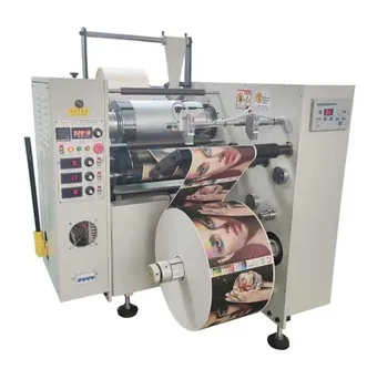 Roll to roll label heat laminate machine processing a printed film roll