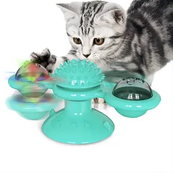 Gray tabby cat playing with a teal windmill cat toy featuring spinning balls and a bristled tickle brush center