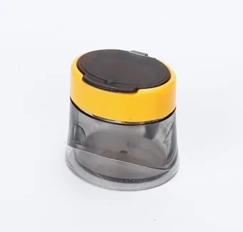 Round portable pencil sharpener with yellow flip-top lid and translucent grey body on a white background