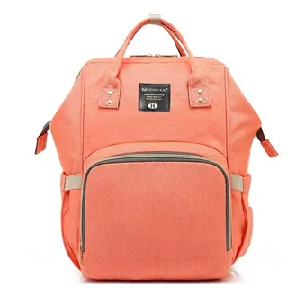 Front view of a coral pink multi-function diaper bag backpack with leather trim accents.