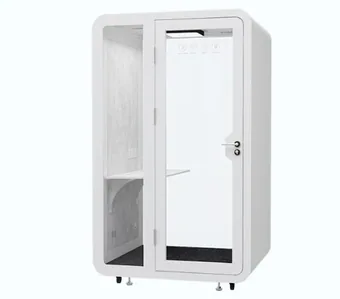 White single-person noise reduction office pod with glass door and interior shelf, isolated on a plain background.