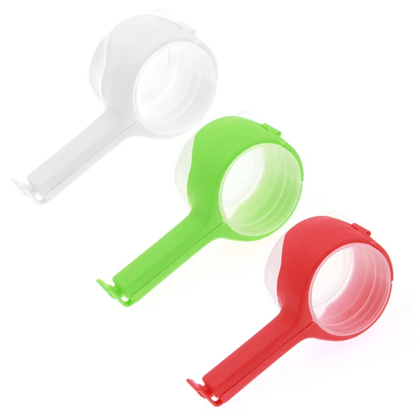 Three round plastic bag sealing clips with handles in white, green, and red on a plain white background