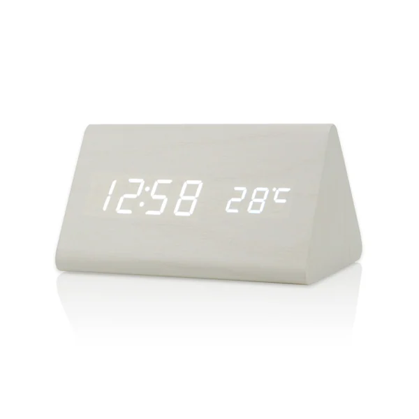 White triangular LED digital alarm clock showing 12:58 and 28 degrees Celsius on its display