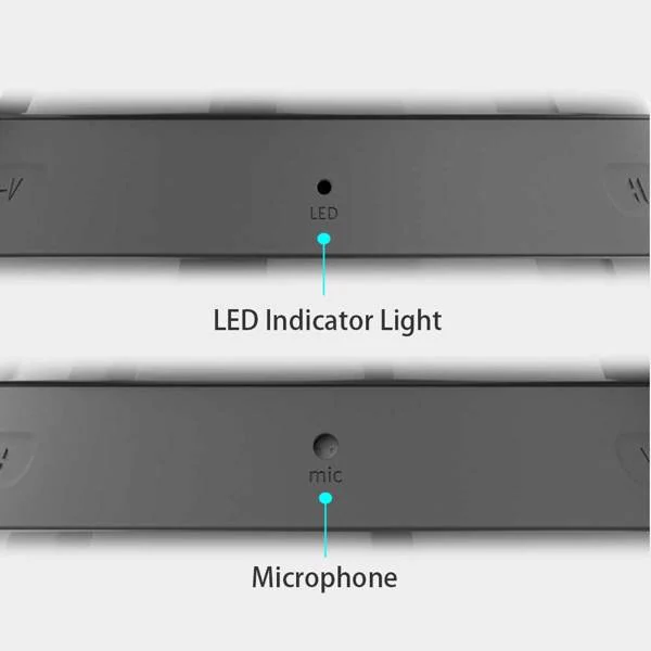 Speaker next to a phone and 3.5mm audio line on a desk