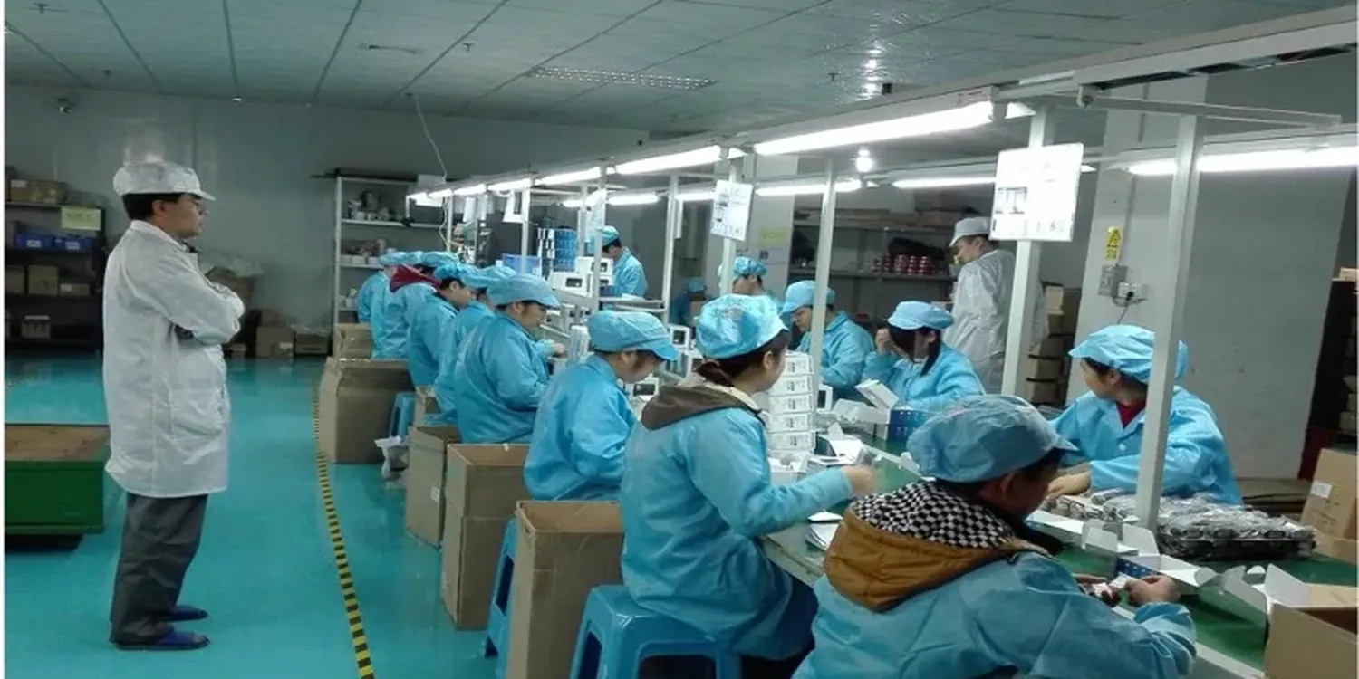 Operators at final assembly and function test stations in the Unique factory
