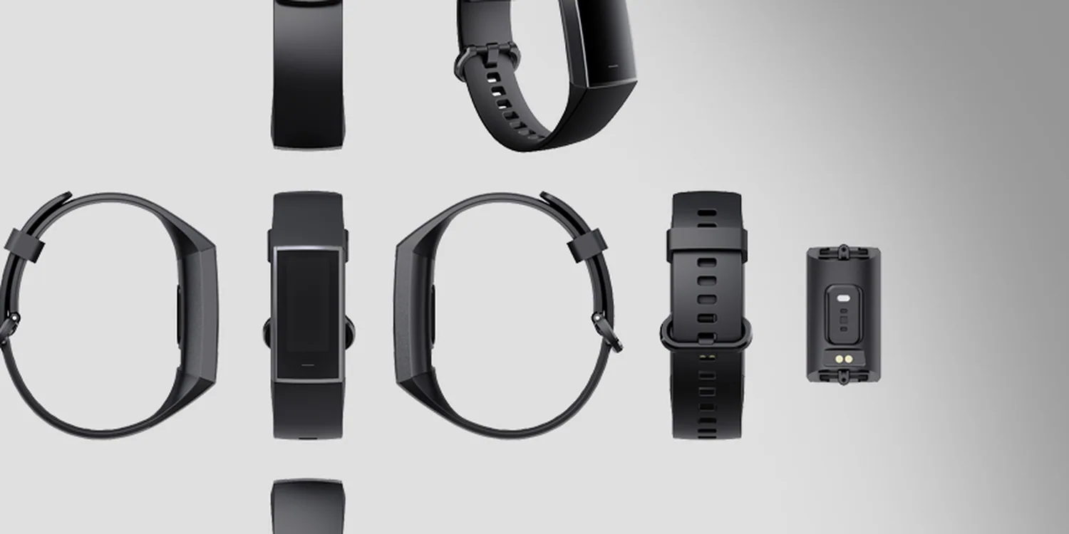 Activity tracker module, straps and charging contacts shown separated