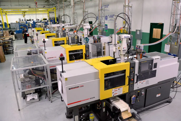 Injection moulding machines running on a production floor