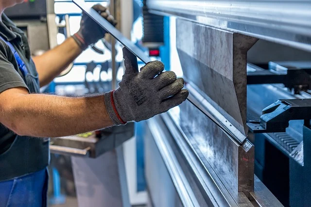 Technician operating a low pressure moulding machine