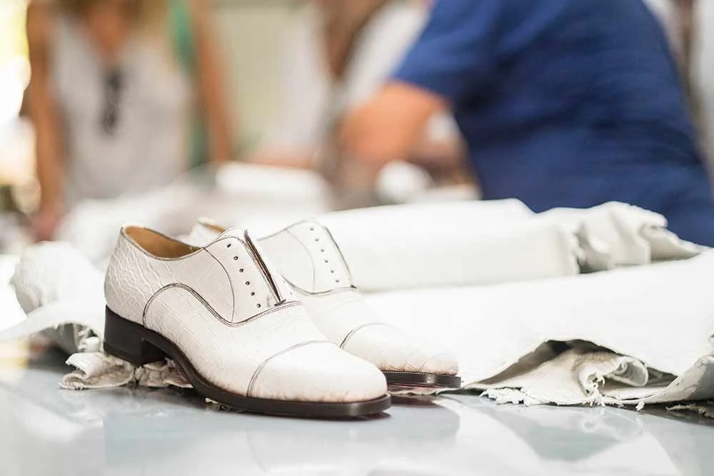 White leather shoe being assembled on the last