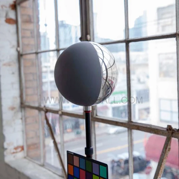 20cm half chrome half grey ball on a stand inside a loft location