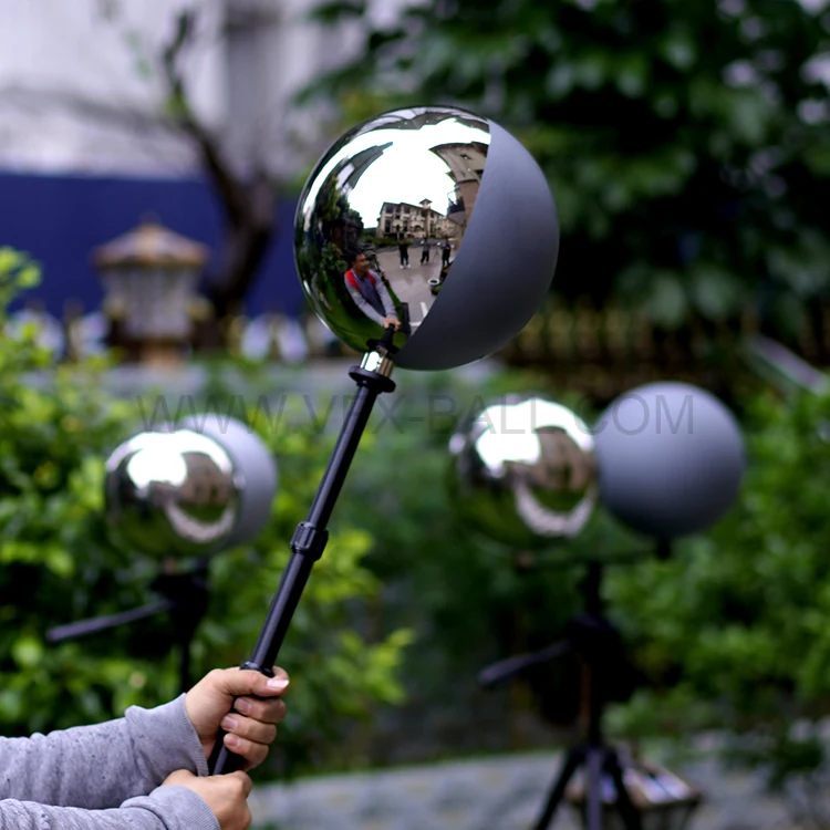 Grey ball and chrome ball held beside a colour checker chart on set