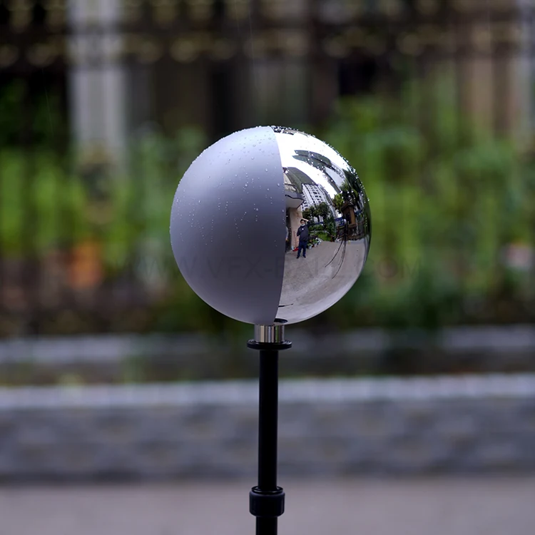 Half mirror half grey VFX ball photographed against a window