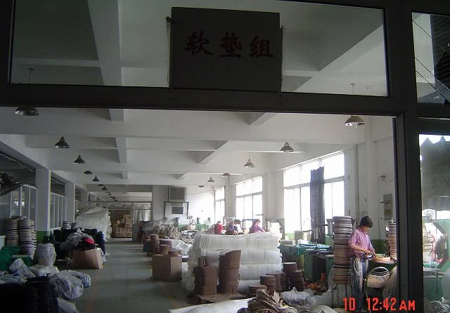 Upholstery and cushion section with rolls of fabric and finished seat pads