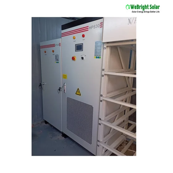 Large industrial cabinet with control panel and red buttons, positioned next to a metal rack frame.