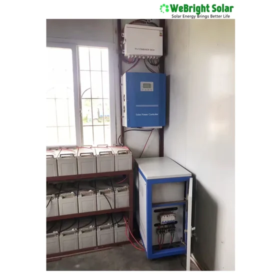 Wall-mounted blue solar inverter and white charge controller above a battery rack and breaker box.