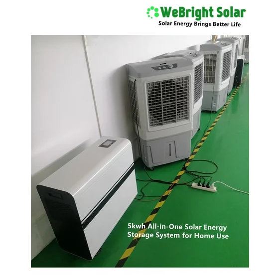 White solar energy storage unit and evaporative coolers on a green factory floor with power cables