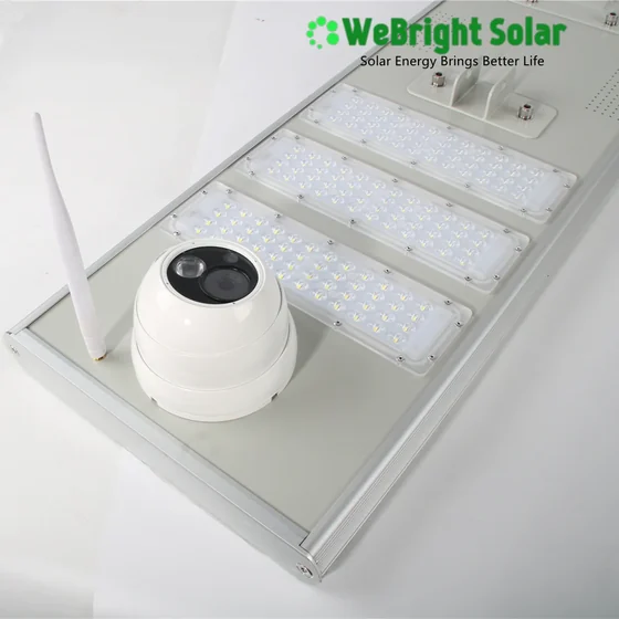 Rear view of a solar light fixture featuring four LED panels, a white dome camera, and an antenna.