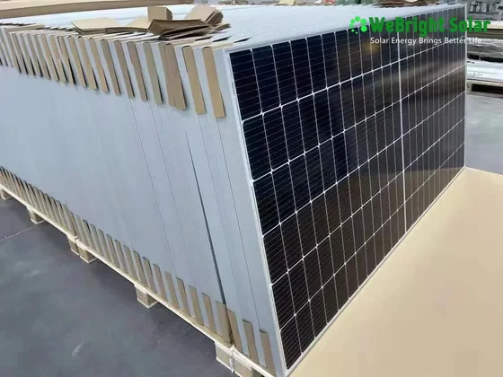 A pallet stacked with solar panels, separated by cardboard dividers and wrapped in protective film.