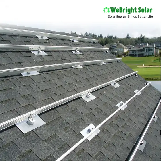 Metal solar panel mounting rails and flashing installed on a shingled roof