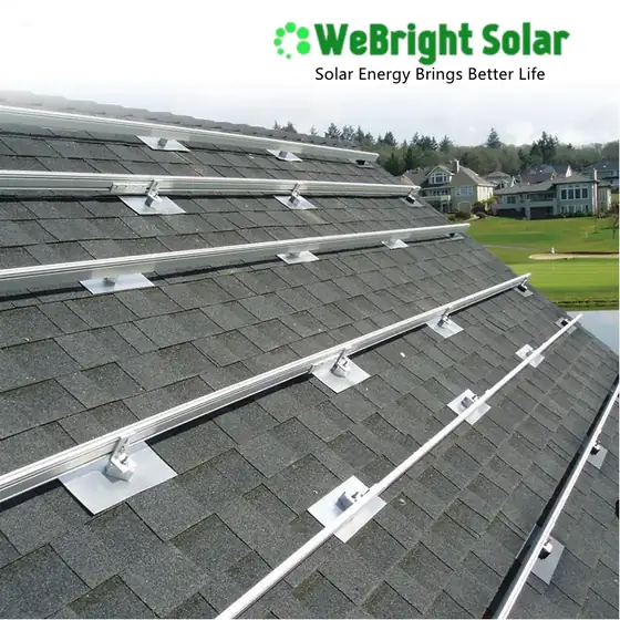 Silver metal solar panel mounting rails and flashing installed on a shingled roof