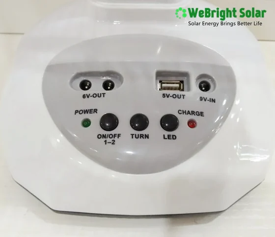 Close up of white solar panel control unit with 6V and 5V output ports, USB port, and control buttons.