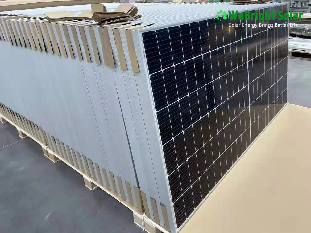 A pallet stacked with solar panels, separated by cardboard dividers and wrapped in protective film.