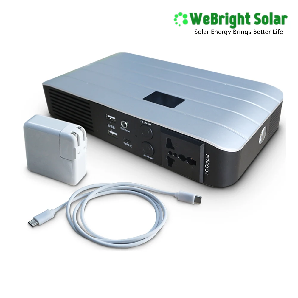 Portable power station with silver top and black front panel showing AC and DC ports, with white adapter and cable