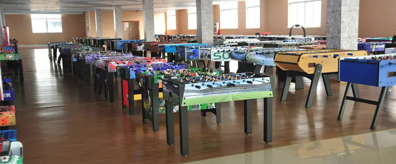 Finished soccer tables in a range of cabinet colours and printed graphics staged in the WEFOR warehouse