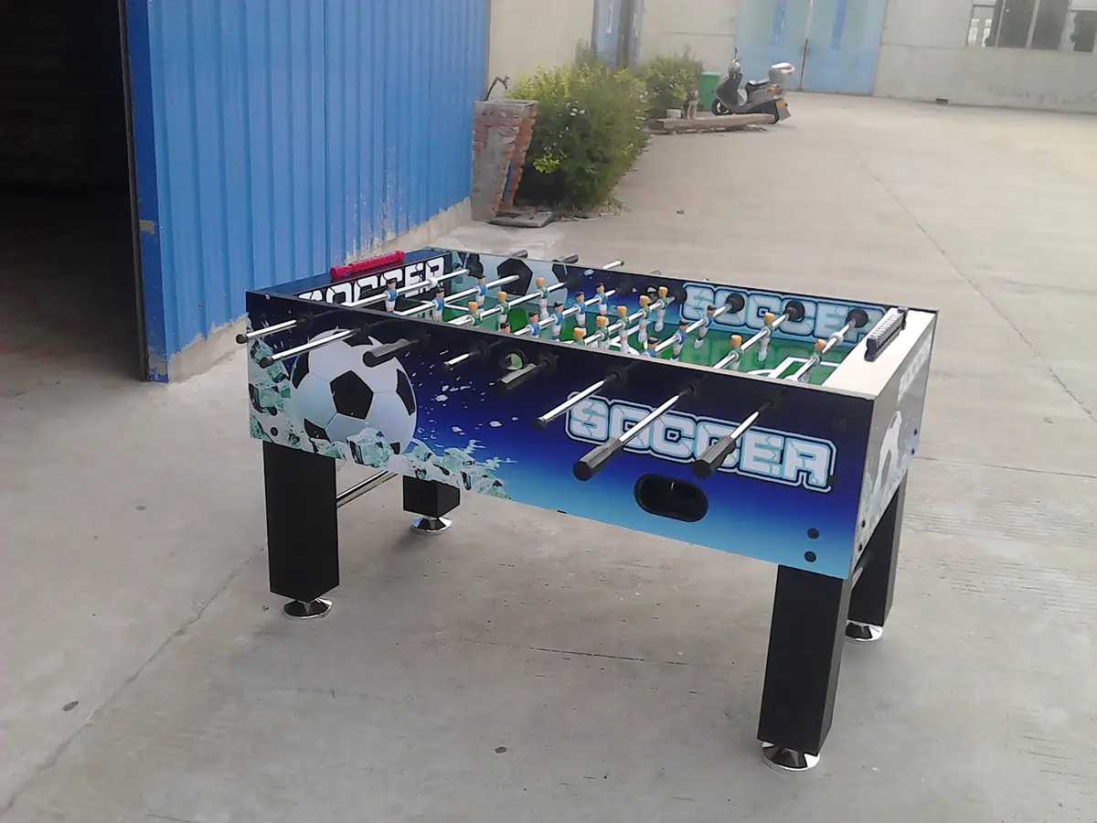 A completed soccer table with printed graphic side panels chrome telescopic rods and levelling feet photographed ou
