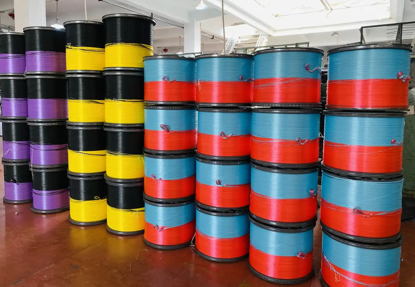 Stacked rolls of coloured polypropylene and polyester webbing ready for despatch