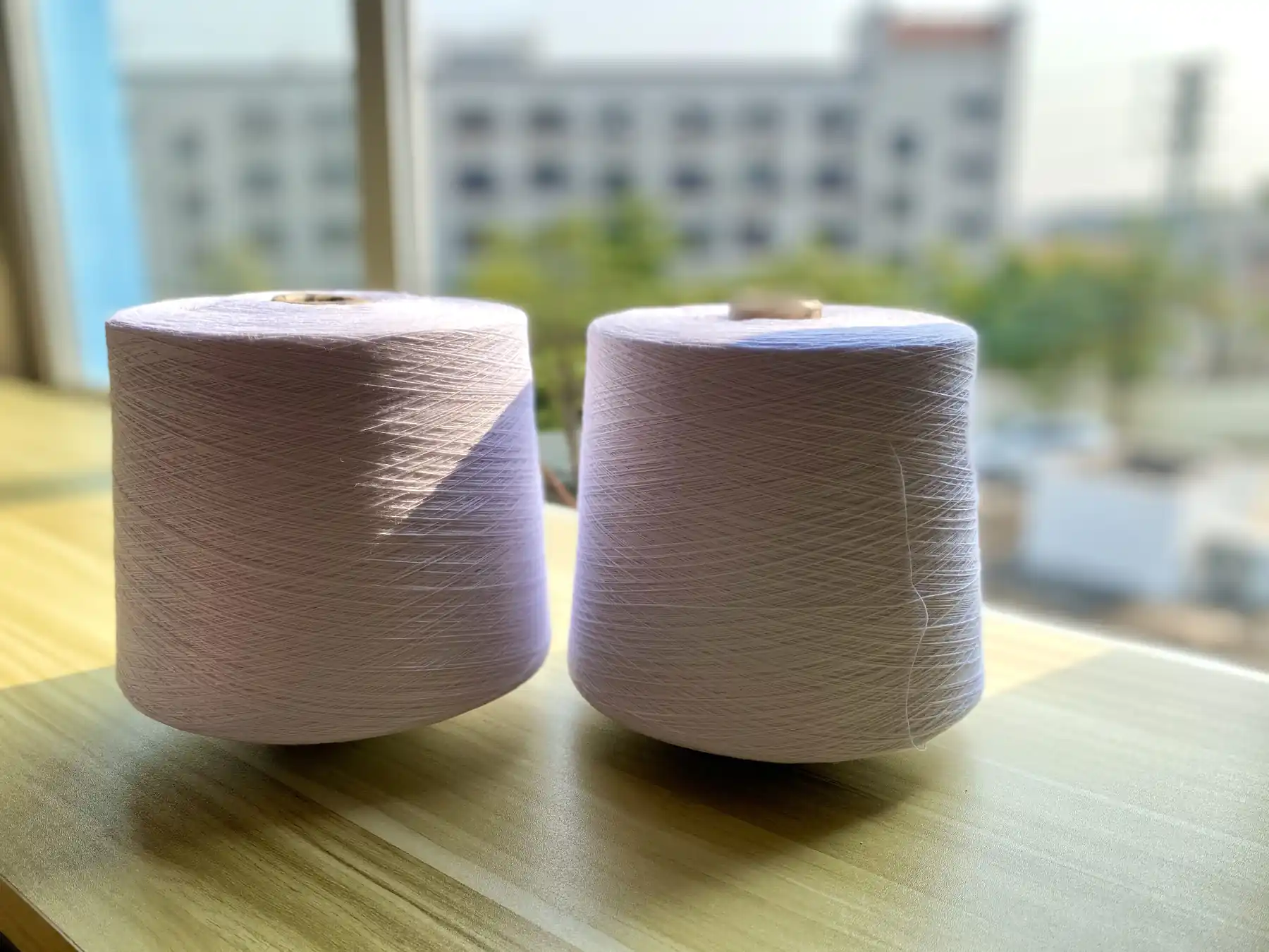 Cotton yarn cones on a bench at the Weiye Webbing factory in Foshan