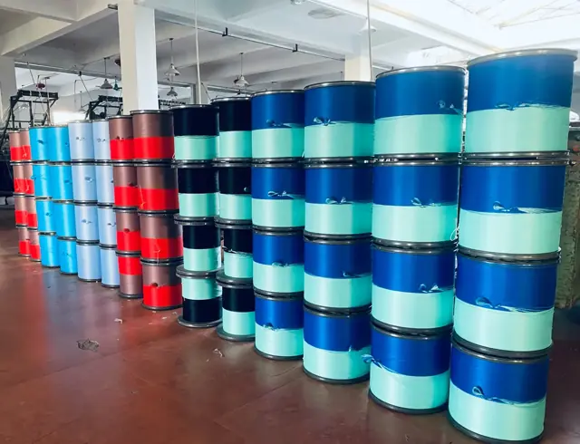 Finished webbing rolls lined up on the mill floor awaiting inspection