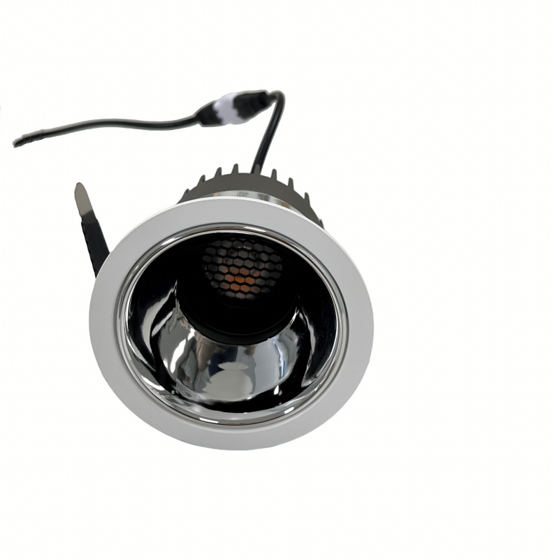 A spool of warm white LED strip lights uncoiling on a brown surface.