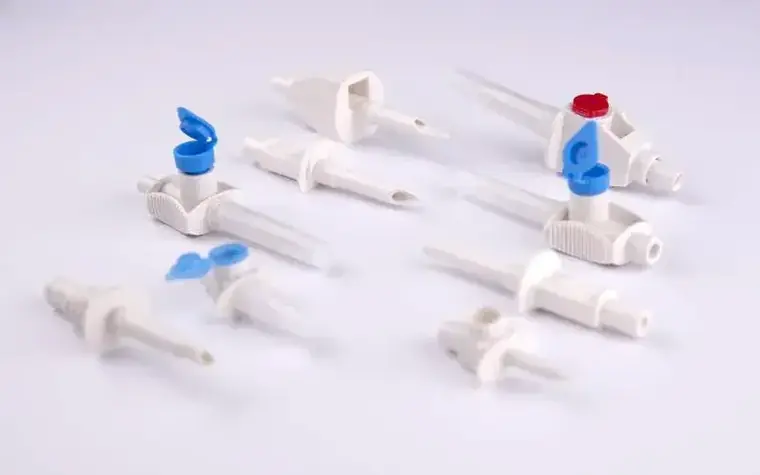 Moulded medical fluid-path connectors and valve bodies arranged on a light surface