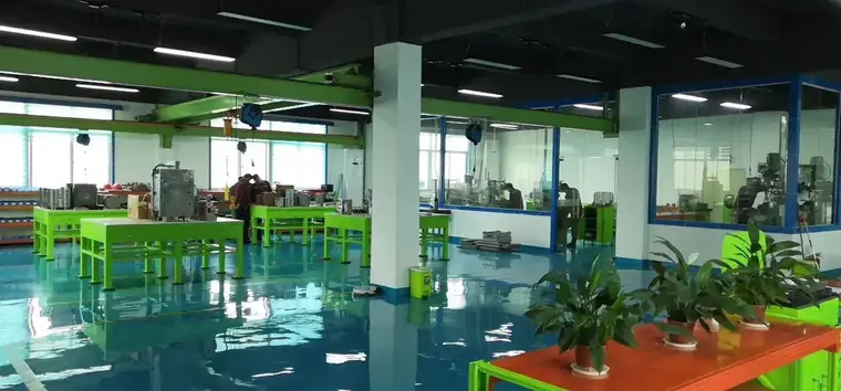 Workshop bay with assembly benches and machining equipment at the Shenzhen site