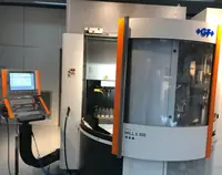 Five-axis machining centre with the work enclosure open on the production floor