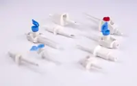 Moulded medical fluid-path connectors and valve bodies arranged on a light surface
