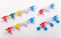 Transparent moulded stopcock assemblies with coloured handles laid out in rows