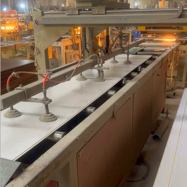WPC panel extrusion line in the factory with boards leaving the profile die