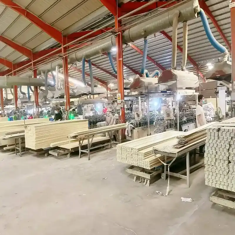 Workshop with extraction ducting above the line and bundles of finished panels on trolleys