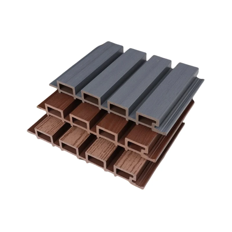 Outdoor WPC wall panels in grey and wood tones stacked to show the fluted hollow profile