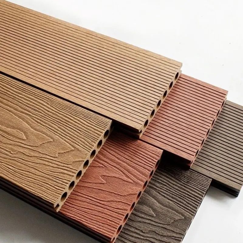 WPC decking boards in several wood tones showing the hollow chambered profile