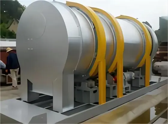 Sulphur drum granulator viewed from the left showing the rotating cylinder shell drive and support rollers