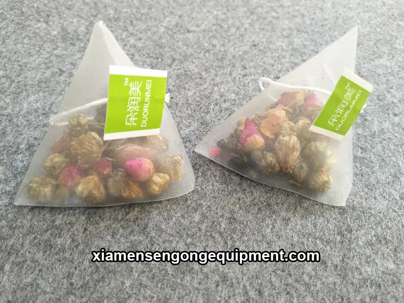 C20DX triangle tea bag packing machine in operation with tea filling