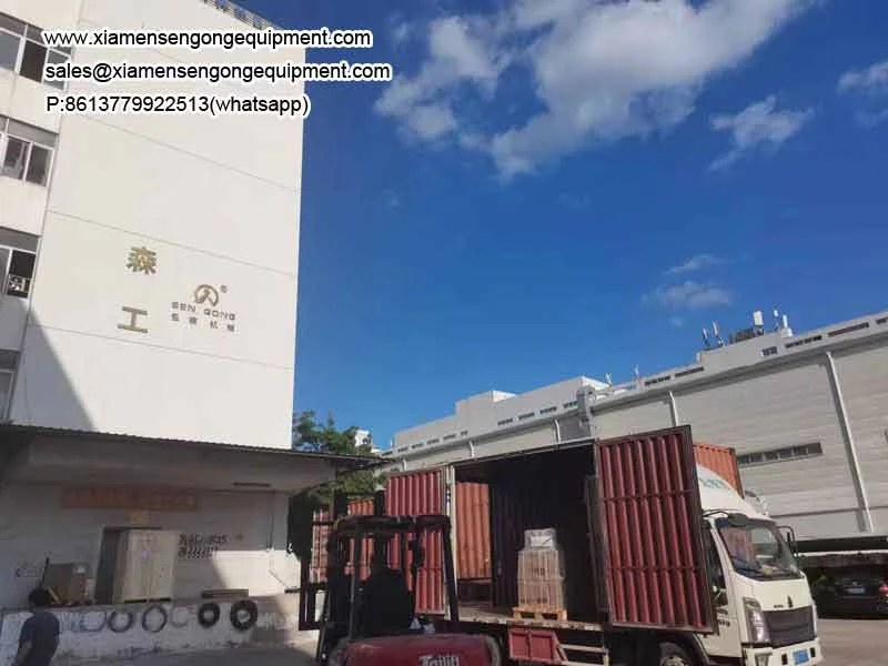 Container being loaded with crated packing machines at the Sengong factory in Xiamen