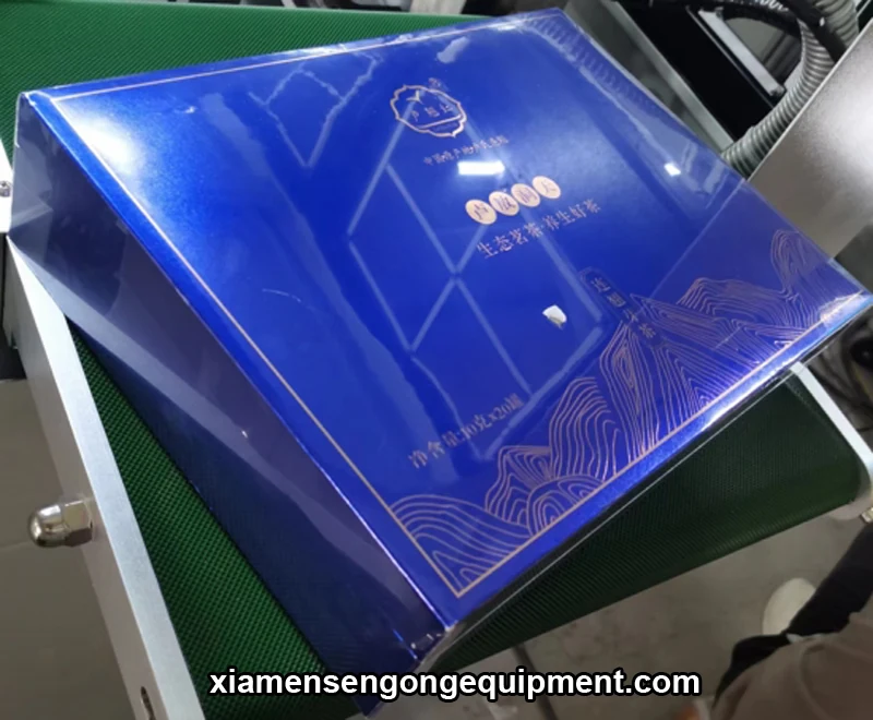 Shrink-wrapped product boxes including mobile phone cases and data cable boxes on the SG400 machine