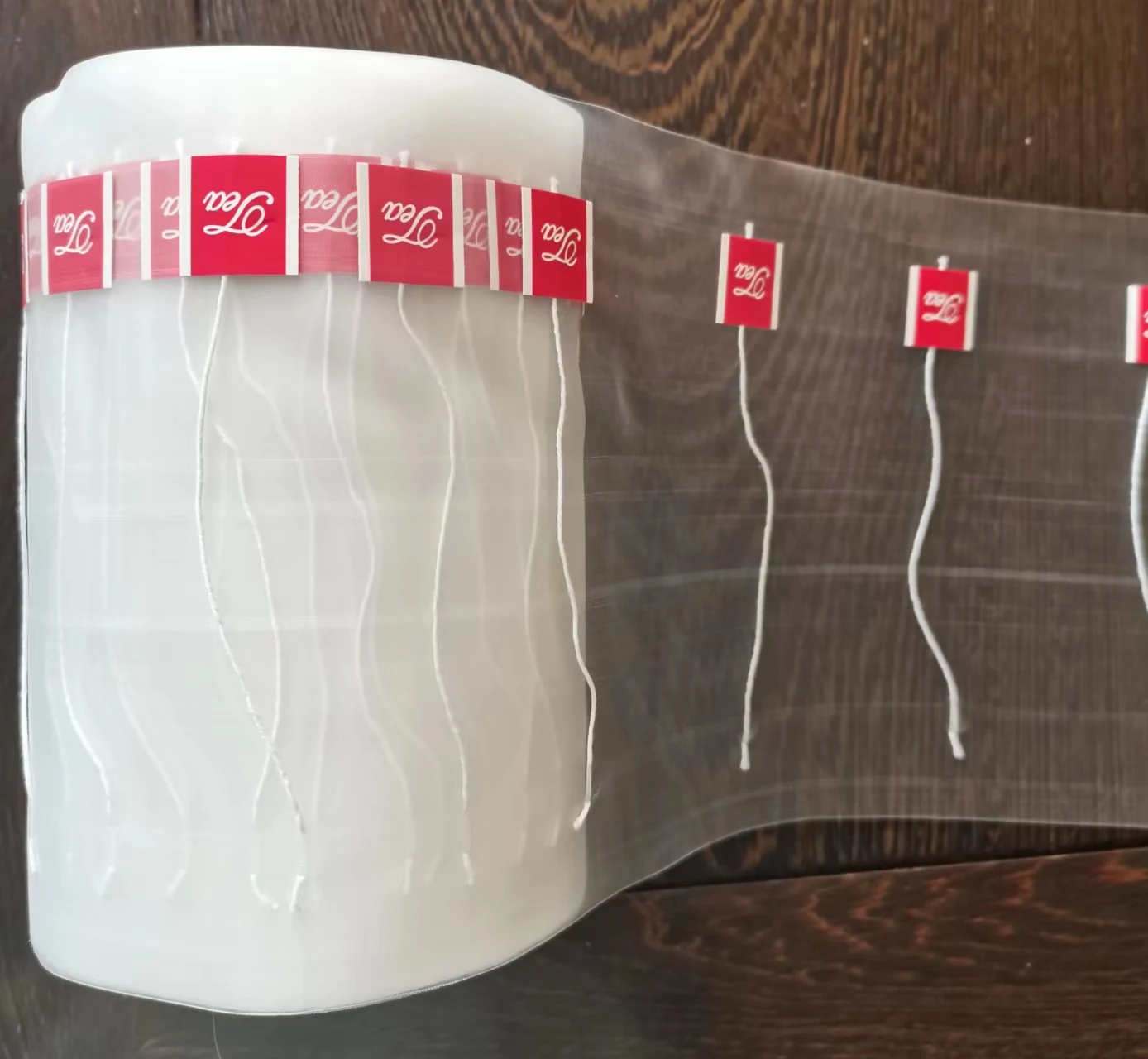 Wide-width film roll with 20x20 mm labels attached using ultrasonic bonding