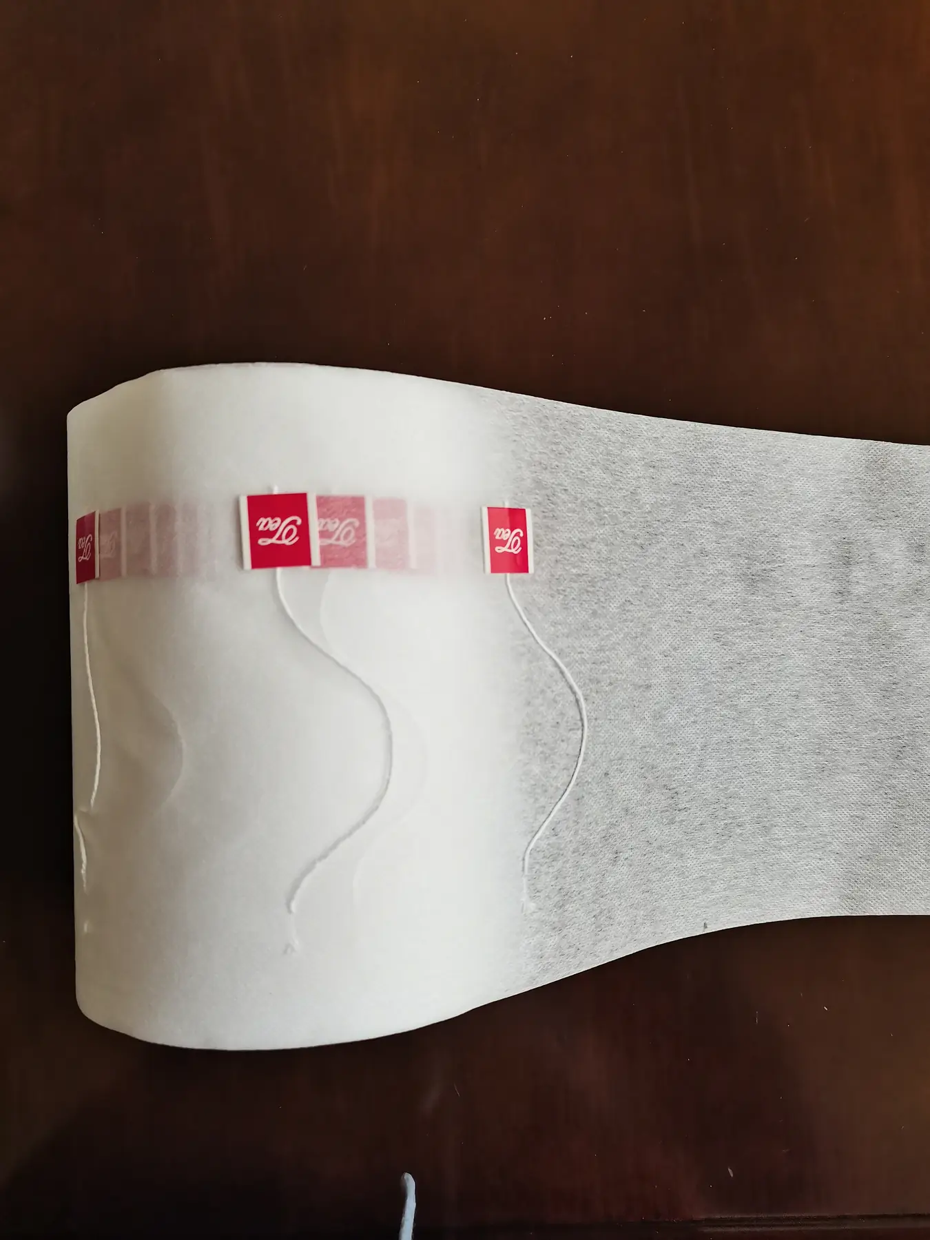 Non-woven fabric film with printed label on the C25 tagging machine